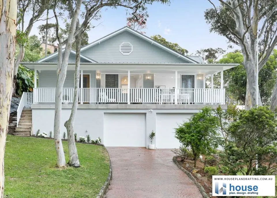 Renovated weatherboard home with a wide verandah above a double garage