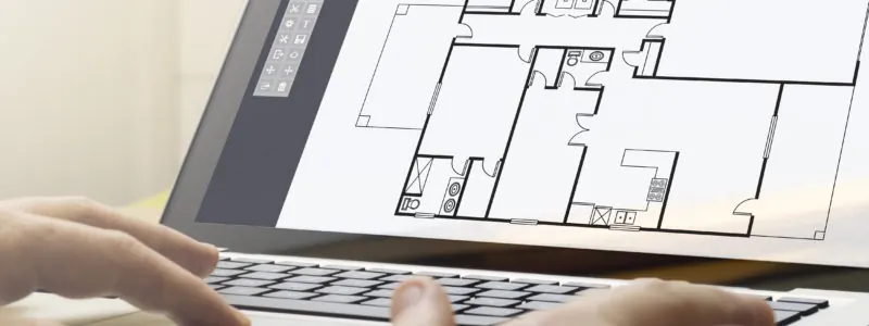 Hands on a laptop keyboard with a house floor plan on the screen